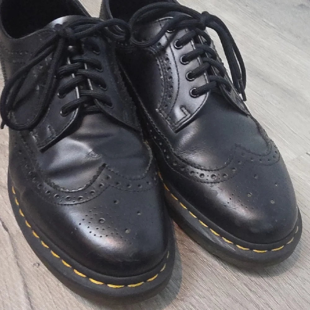 Dr. Martens Black Leather Wingtip Oxfords with Yellow Stitching